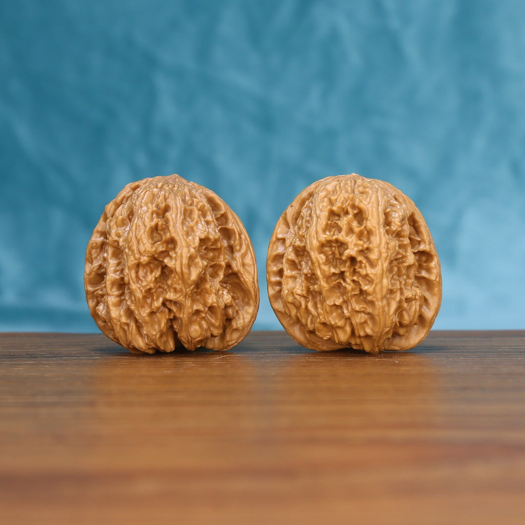 Front view of a matched pair of General Wenwan walnuts with bold natural texture

