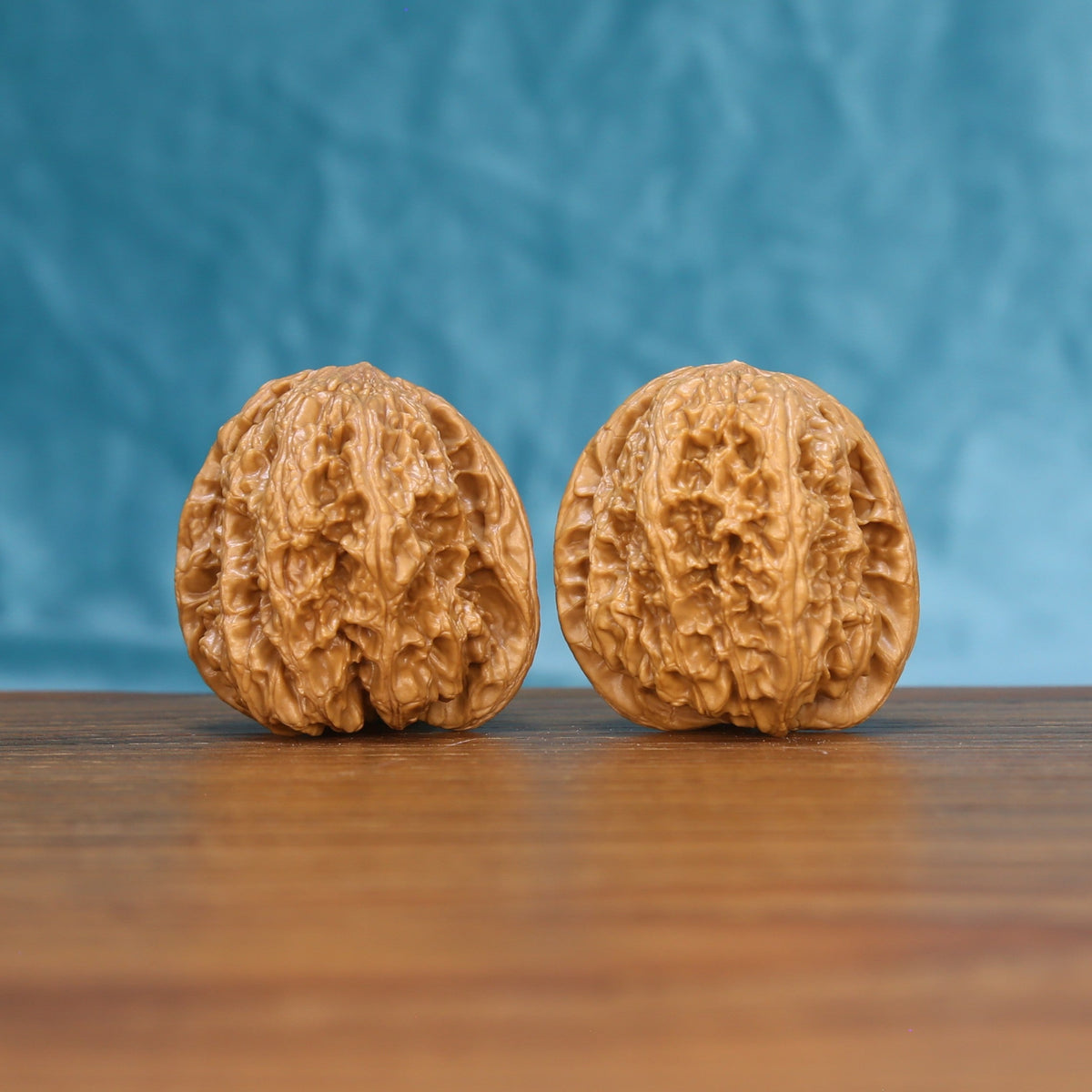 Front view of a matched pair of General Wenwan walnuts with bold natural texture
