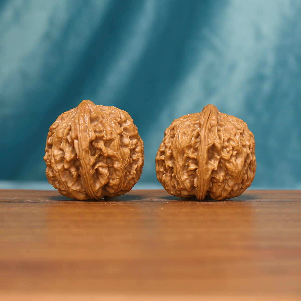 The Emberstone Twins L37 walnut pair showing dense natural ridges and rough texture
