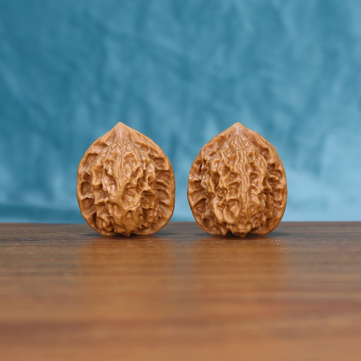 Front view of a matched pair of Linglong Wenwan walnuts with natural textured shells
