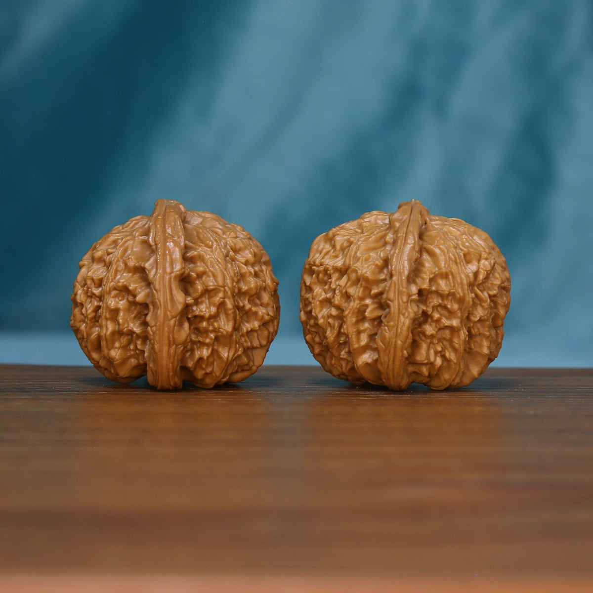 Side view of two S46 White Lion wenwan walnuts with pronounced ridges

