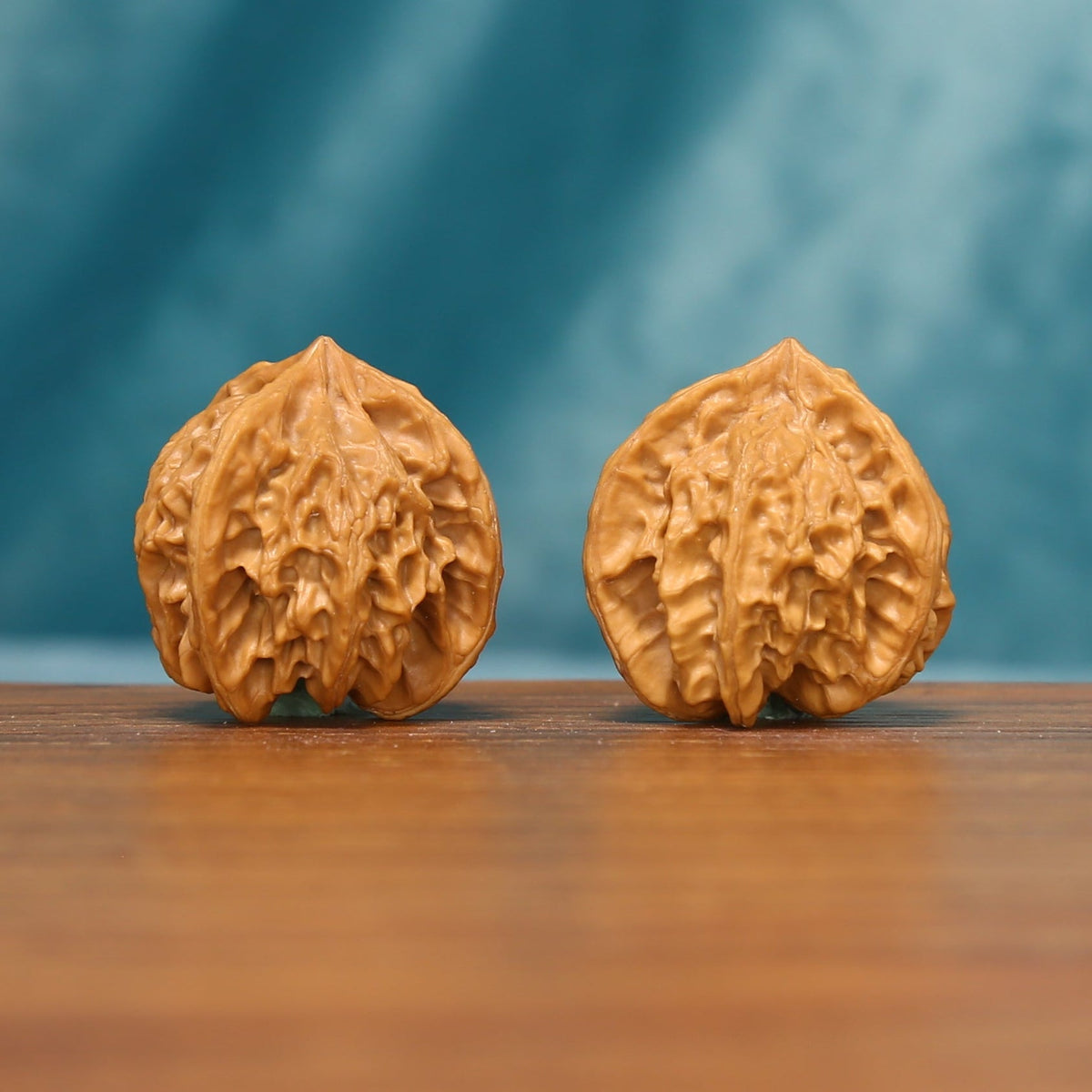 L23 Wenwan walnut matched pair shown from the front, displaying detailed ridge texture and individual surface character.
