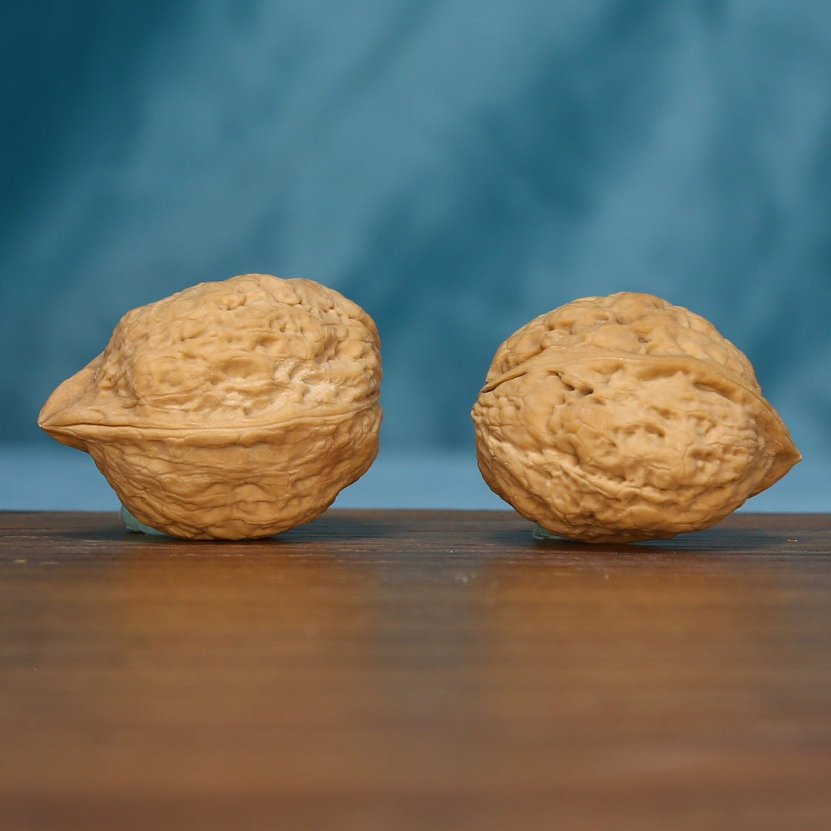 Side view of the L41 Three-Ridge Iron Walnut pair with textured tan surfaces
