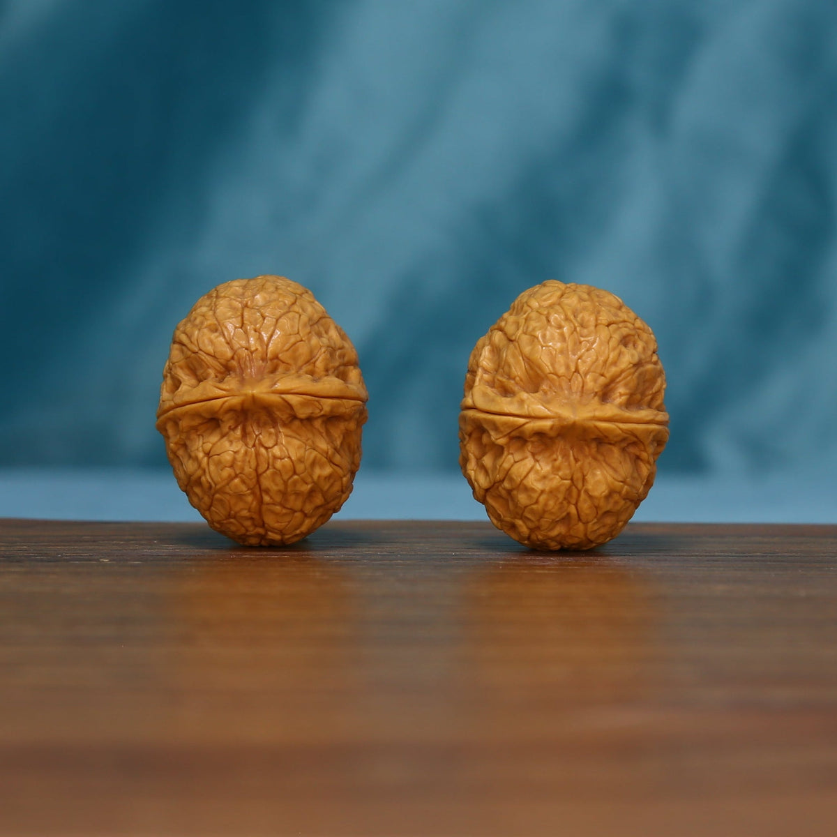Pair of 163 wenwan walnuts standing upright with raised bands across their shells
