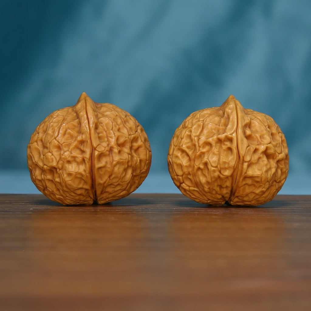 Alternate end view of the 163 wenwan walnut pair with branching ridges
