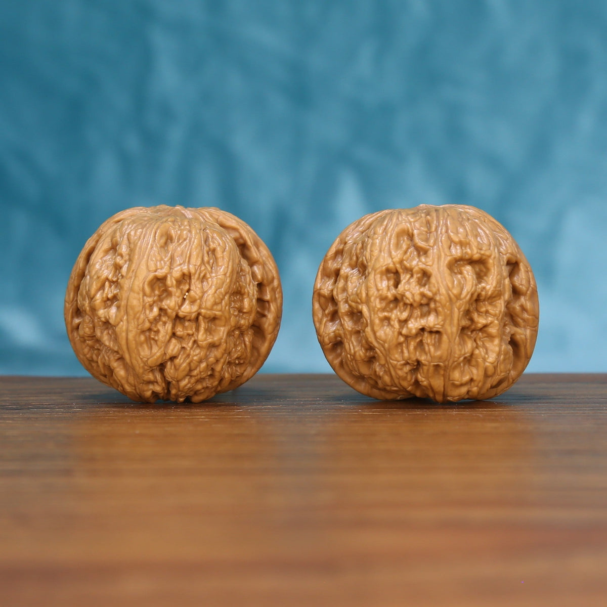Front view of a matched pair of General Wenwan walnuts with bold natural texture
