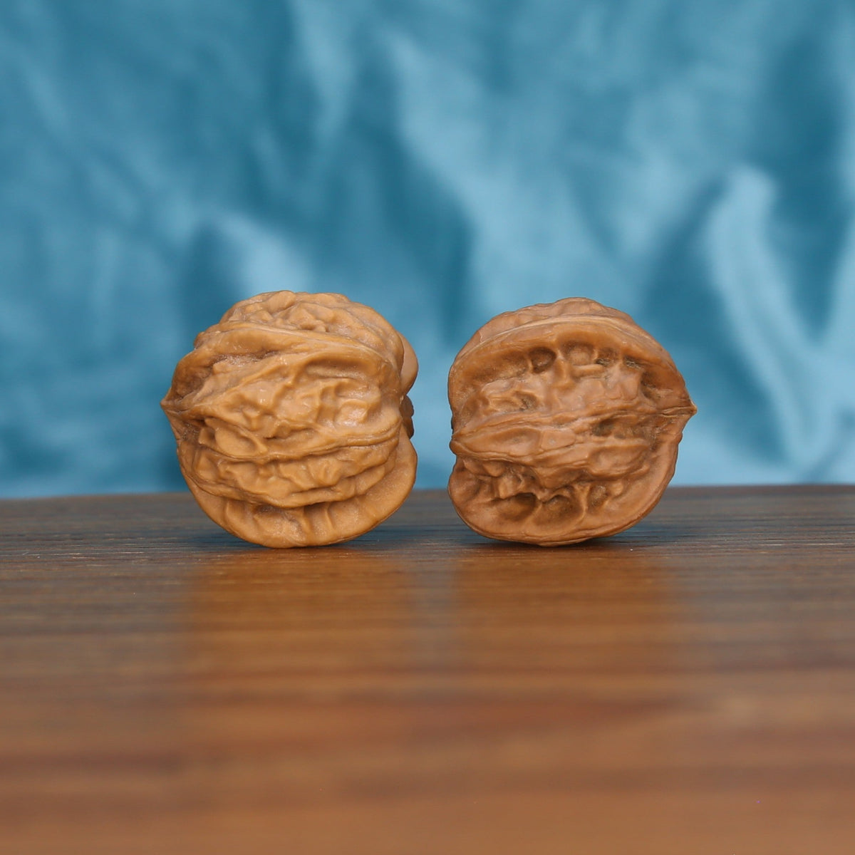 Single Qi-Da-Hai San-Leng wenwan walnut bottom view on wooden surface – natural base and three-ridge texture detail