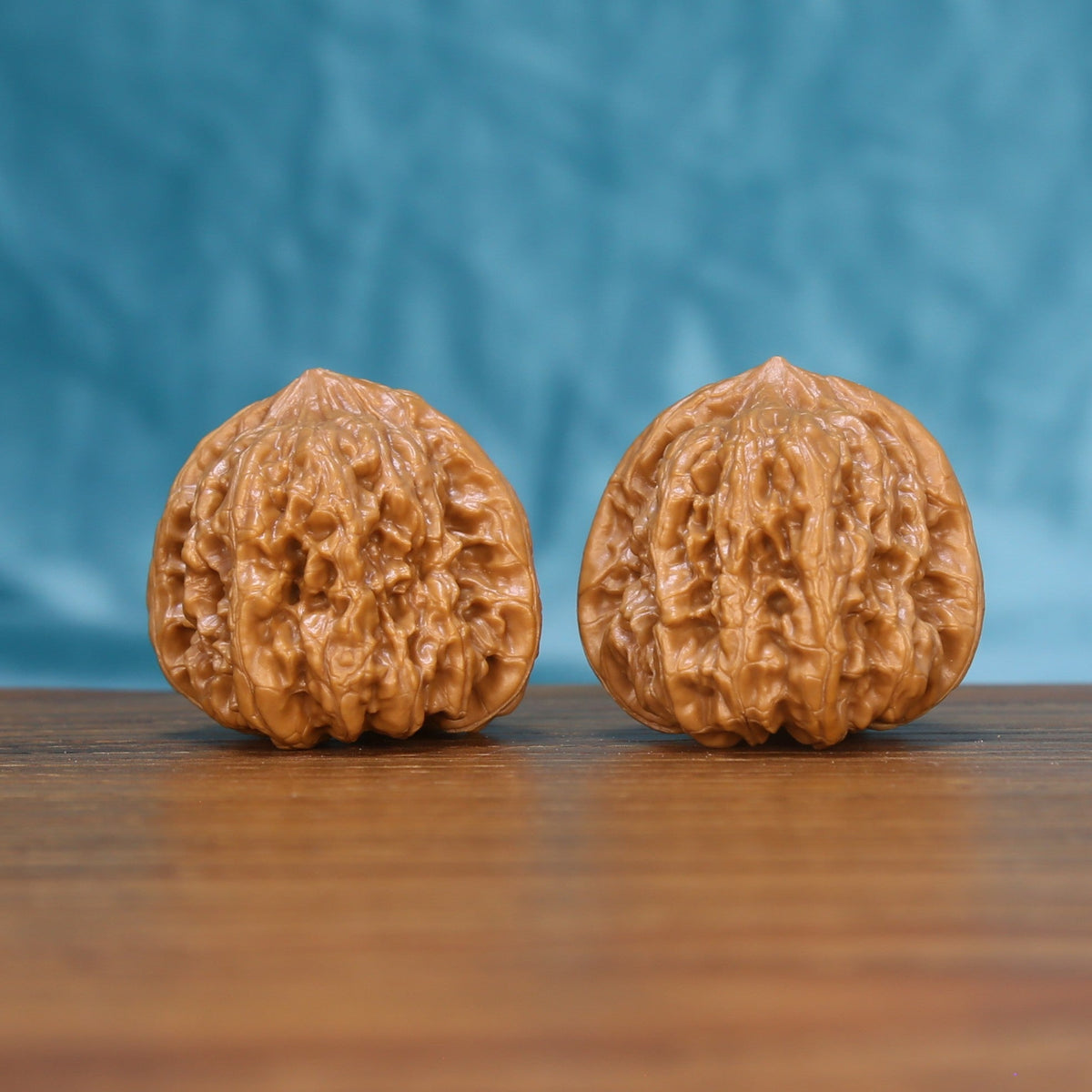 Front view of a matched pair of Pinggu Concave Base Wenwan walnuts with natural shell texture
