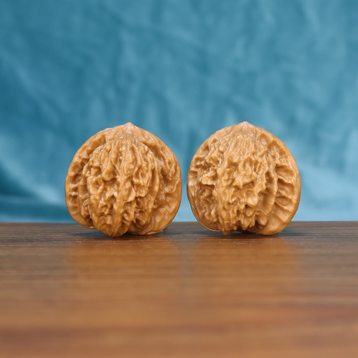 Front view of a matched pair of Coiling Dragon Wenwan walnuts with flowing natural ridges
