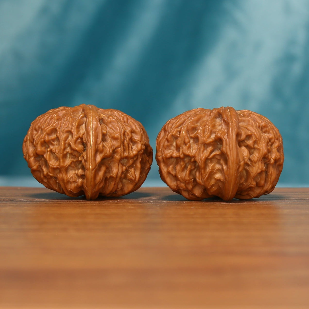 Close view of the Millstone Wenwan walnut pair showing the textured natural surfaces
