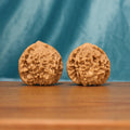 Front view of The Scholar's Cap Wenwan Walnut Set showing two large rounded walnuts with pronounced crown-like ridges.
