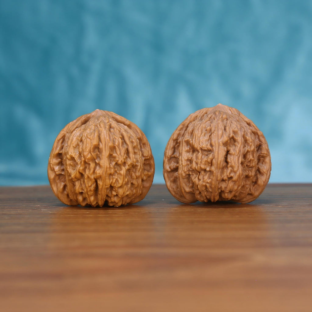 Wu-Ming walnut set side profile on wood, blue background – mountain echo natural grain detail
