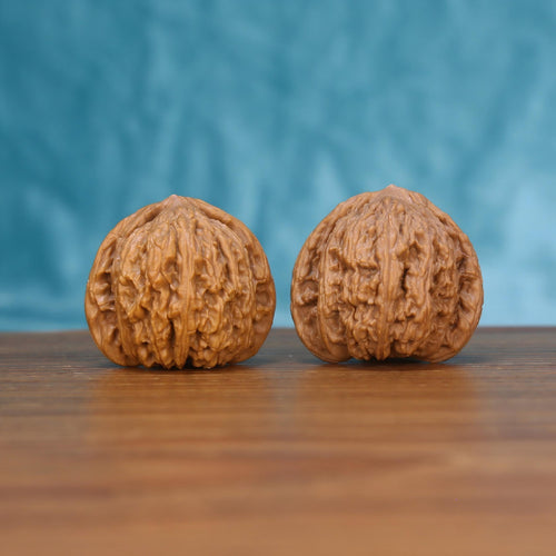 Wu-Ming walnut set side profile on wood, blue background – mountain echo natural grain detail