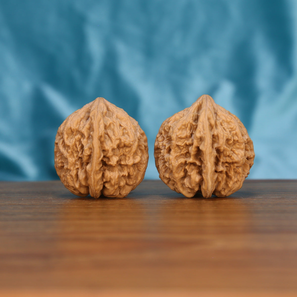 Da-Cu-Jin wenwan walnut pair alternate angle, blue background – symmetrical earthborn monolith ridge pattern