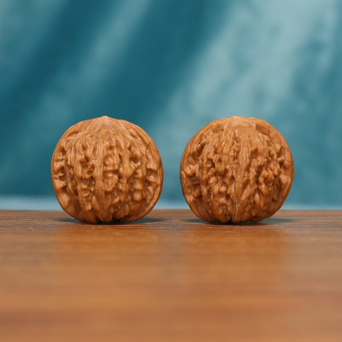 Shanxi Han Gaolou Wenwan walnut pair showing the carved ridges and rounded form

