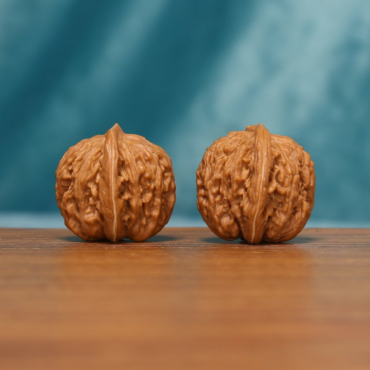 Close view of the Shanxi Han Gaolou Wenwan walnut pair from an angled front view
