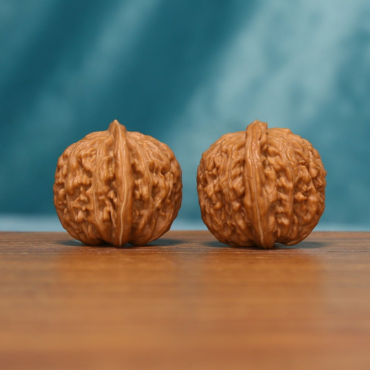 Shanxi Han Gaolou Wenwan walnut pair showing both textured carved surfaces
