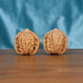 Single Qi-Da-Hai San-Leng wenwan walnut bottom view on wooden surface – natural base and three-ridge texture detail