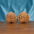 Two Man-Tian-Xing wenwan walnuts on wooden surface, blue fabric background – matching celestial constellation set