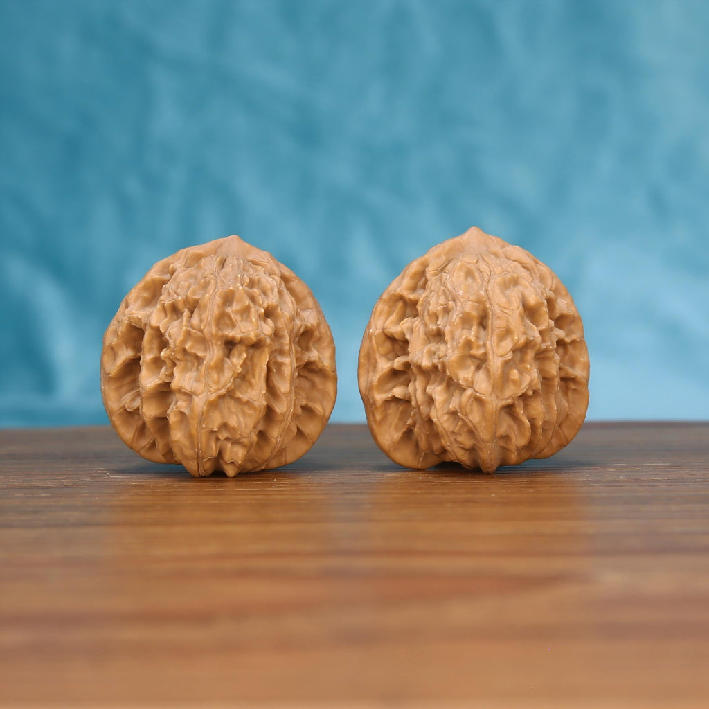 Two Wu-Ming wild wenwan walnuts on wooden surface, blue fabric background – matching wind-carved ridge nameless wild set