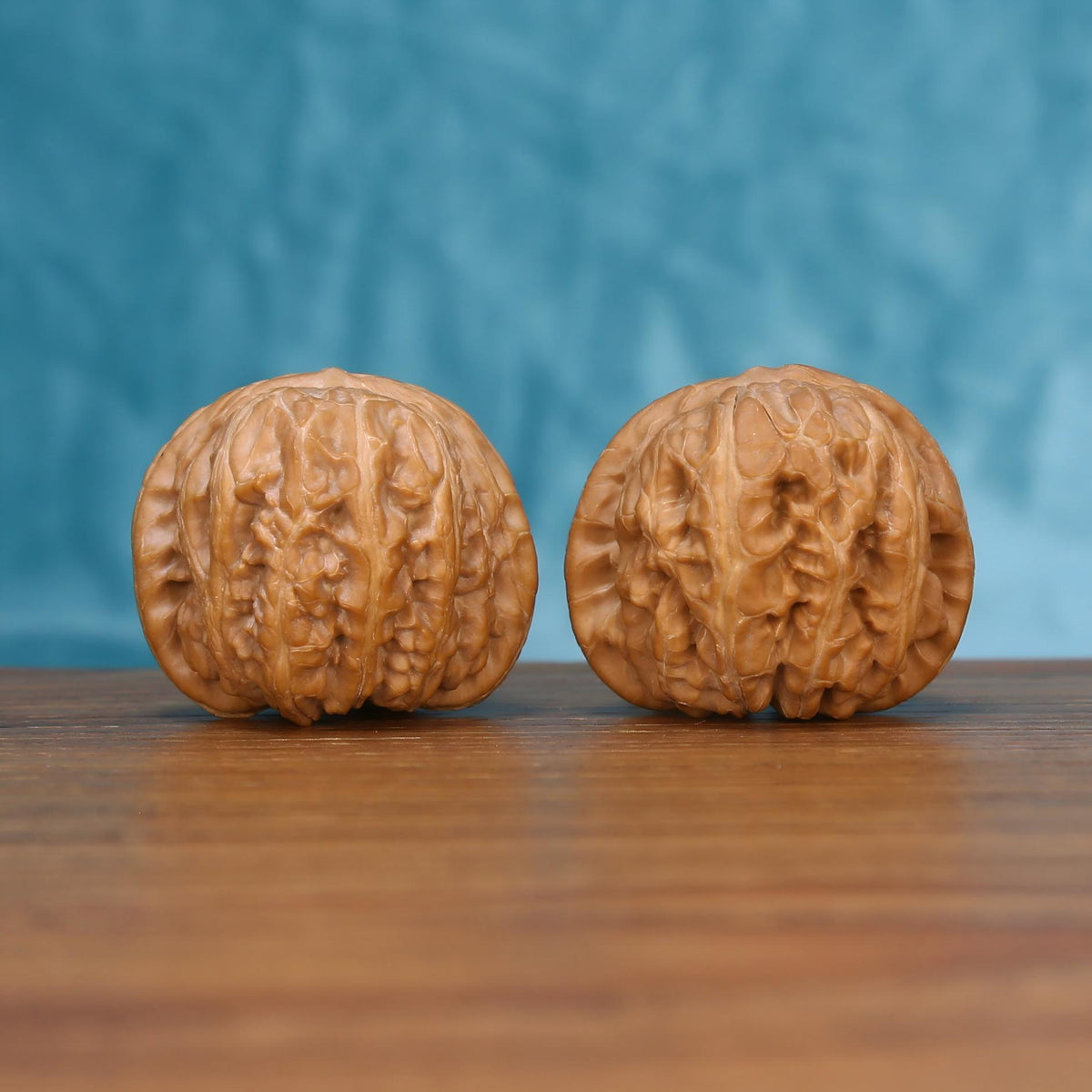 Front view of the Yuan-Bao walnut pair showing detailed natural ridges
