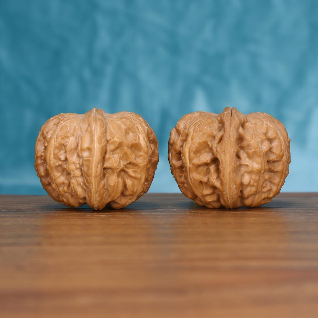 Close-up view of the textured Yuan-Bao walnut pair