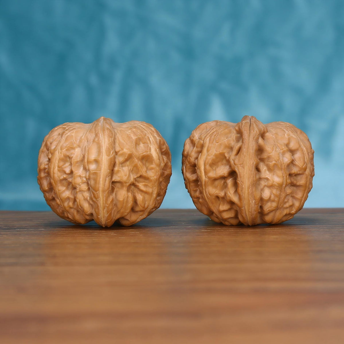 Close-up view of the textured Yuan-Bao walnut pair
