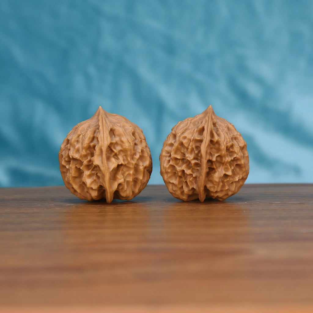 Single Ling-Long wenwan walnut bottom view on wooden surface – natural base and intricate carved texture detail