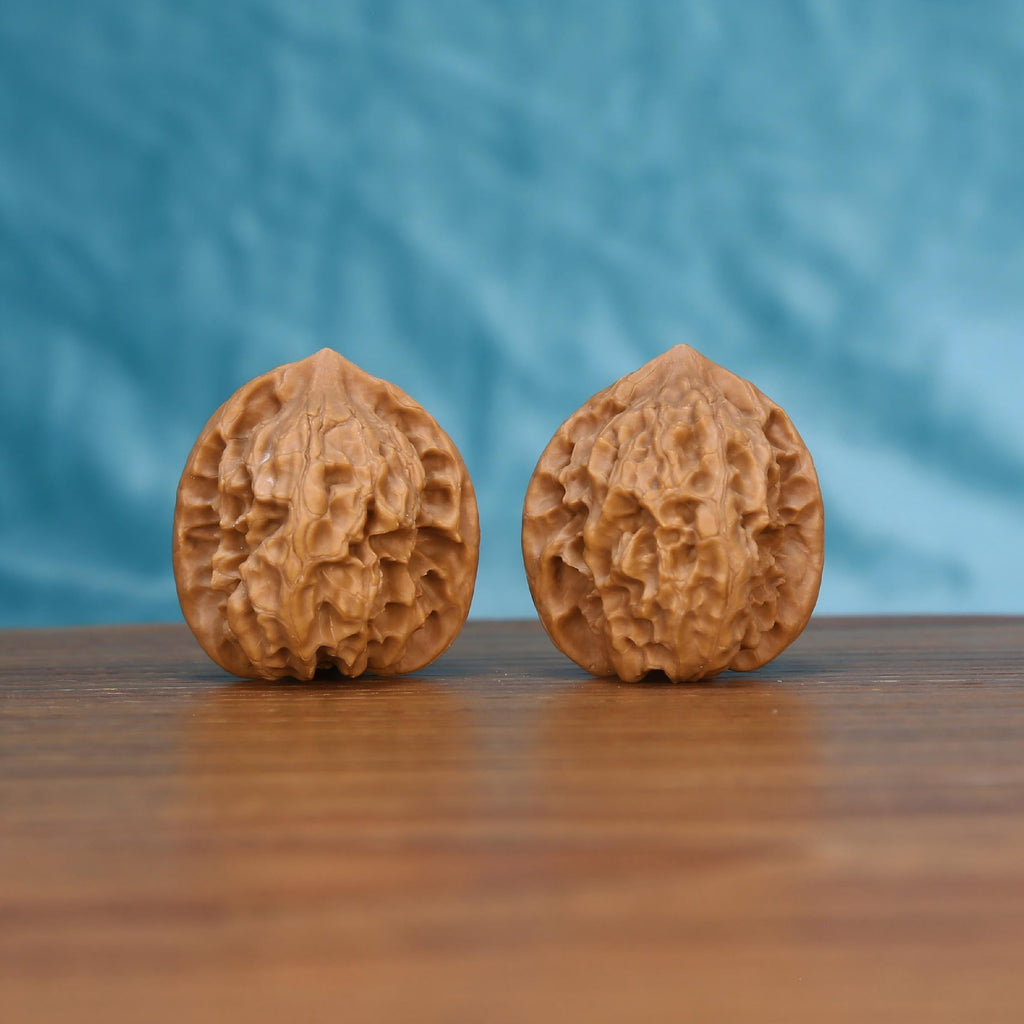 Ling-Long walnut pair bottom view on wood – natural hollow-carved base pattern, Exquisite Enigma premium set