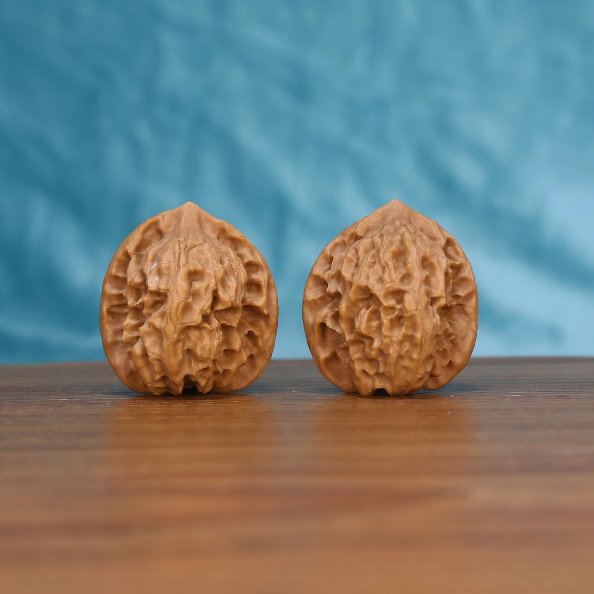 Ling-Long walnut pair bottom view on wood – natural hollow-carved base pattern, Exquisite Enigma premium set