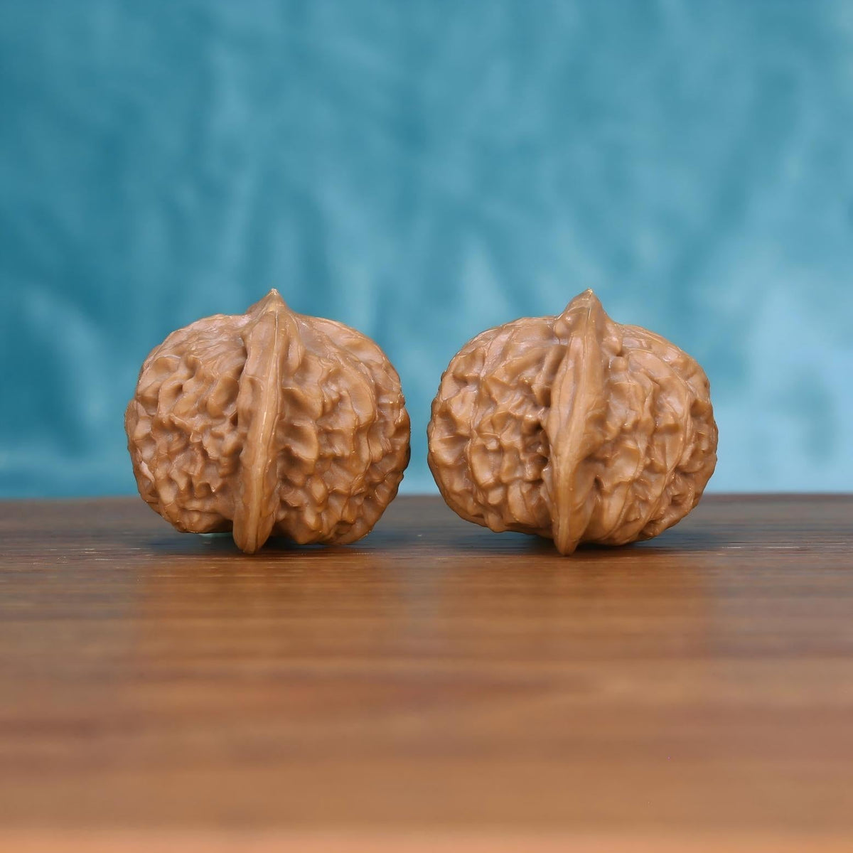  Single Gong-Deng wenwan walnut on wooden surface, blue background – intricate lantern-shaped natural texture close-up