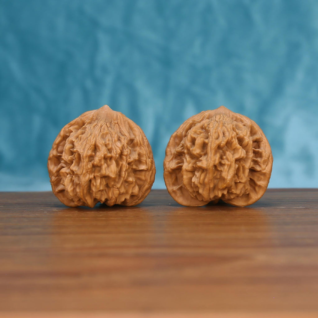 Mai-Sui-Hu-Tou walnut set side profile on wood, blue background – wheat-spike tiger-head grain detail