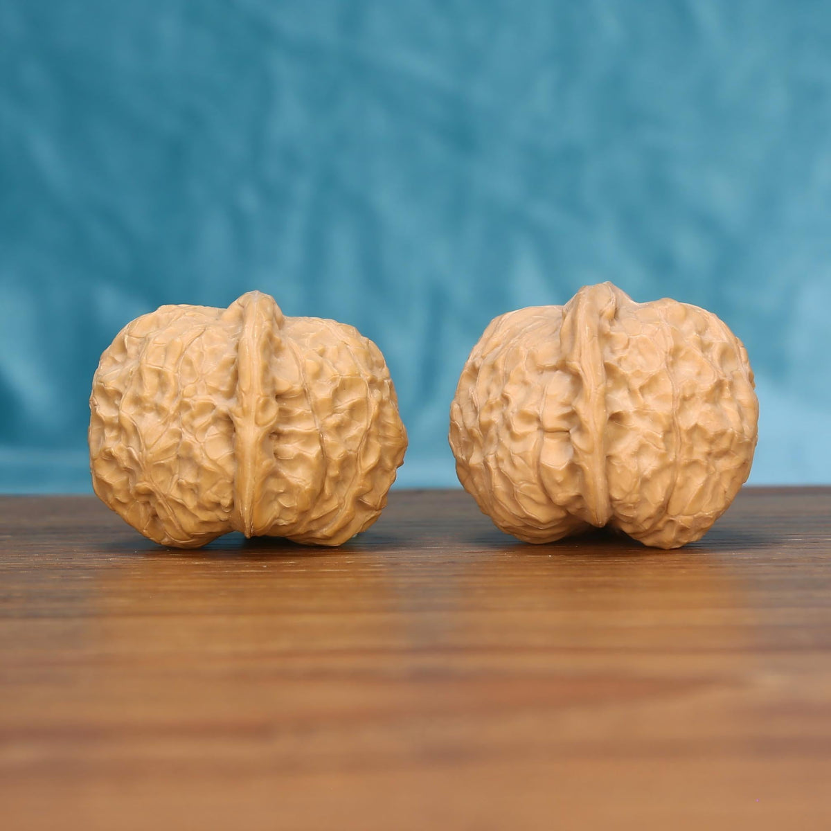  Nan-Gua-Dun wenwan walnut pair alternate angle, blue background – symmetrical earthbound bastion ridge pattern